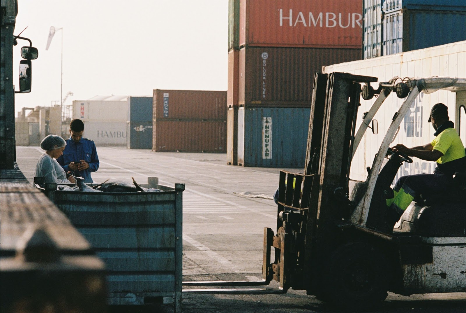 Workers inside of a shipping yard warehouse