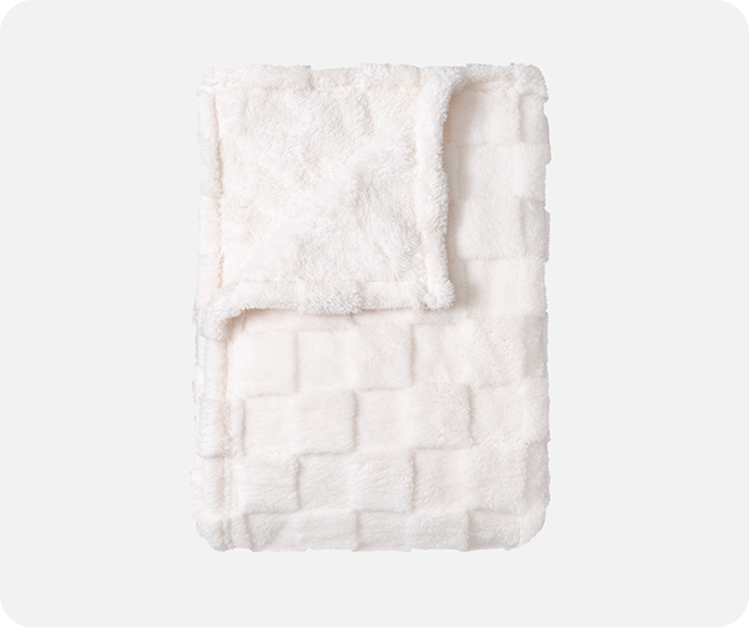Our white Checkered Teddy Throw in Natural shown folded on a white background.