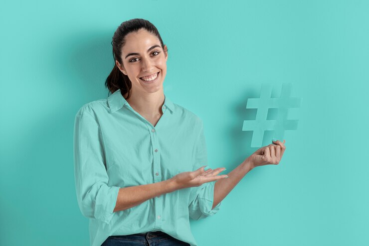 woman holding a hashtag sign