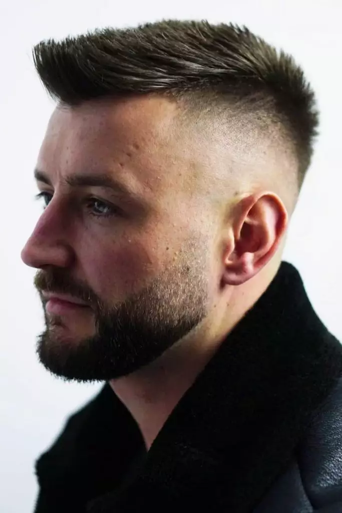 Side view of a guy wearing the short mohawk  haircut style 
