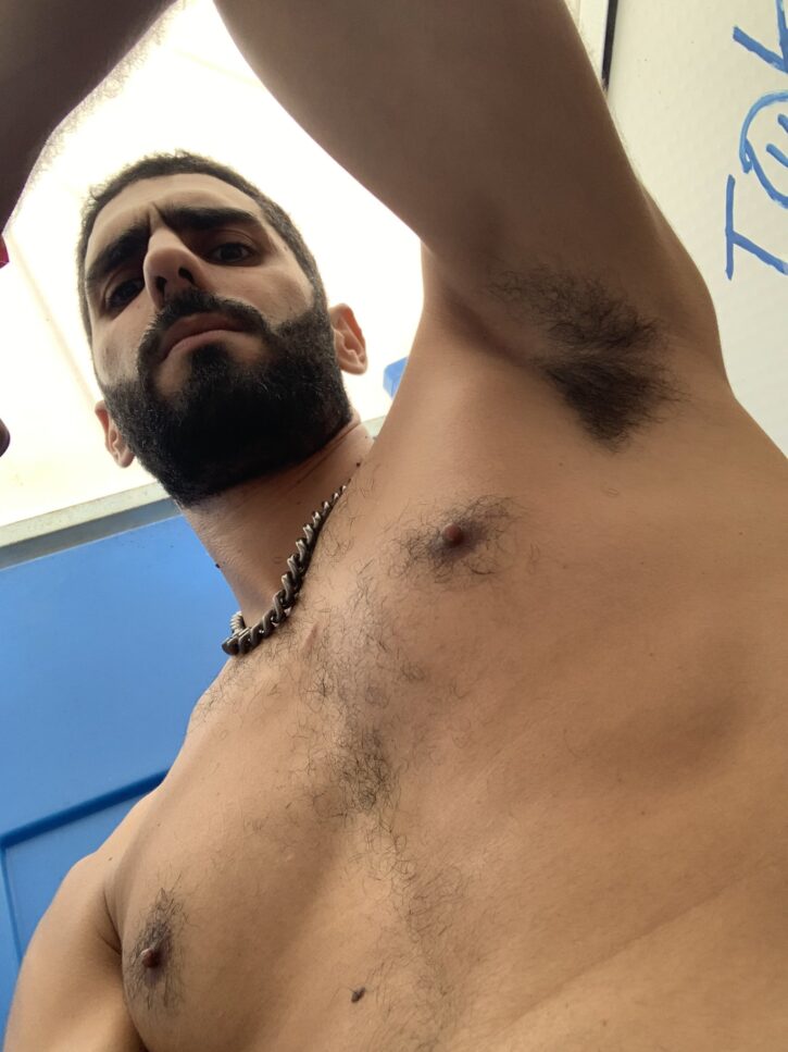 karim yoav shirtless looking down at his iphone selfie