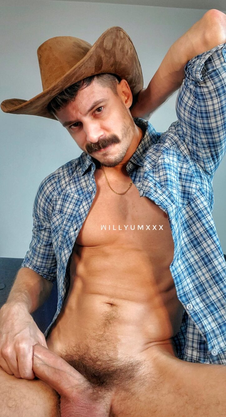 william miguel posing in a checkered button shirt and cowboy hat with no pants showing off and stroking his hard fat cock