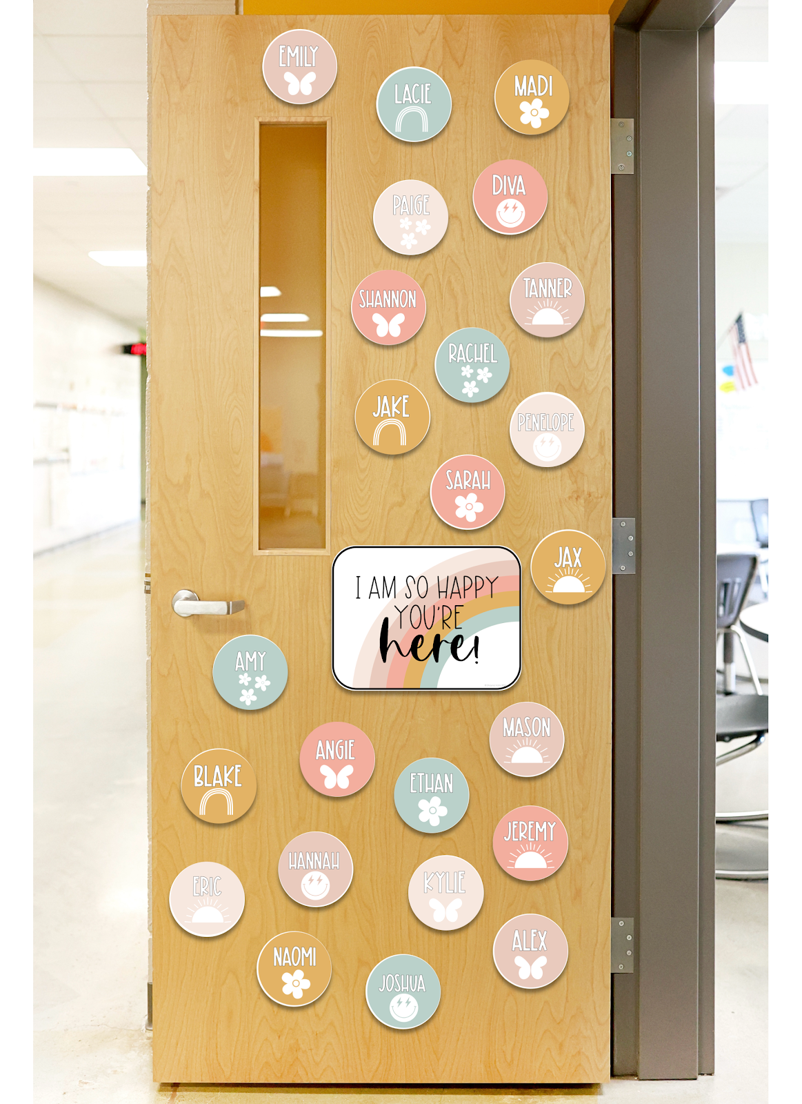 This image shows a classroom door decorated with lots of circles. Each circle has a student's name written on it with a clipart image of a flower or sunshine or flowers. There is a large sign that says "I'm so happy you're here" in the middle of the door. 