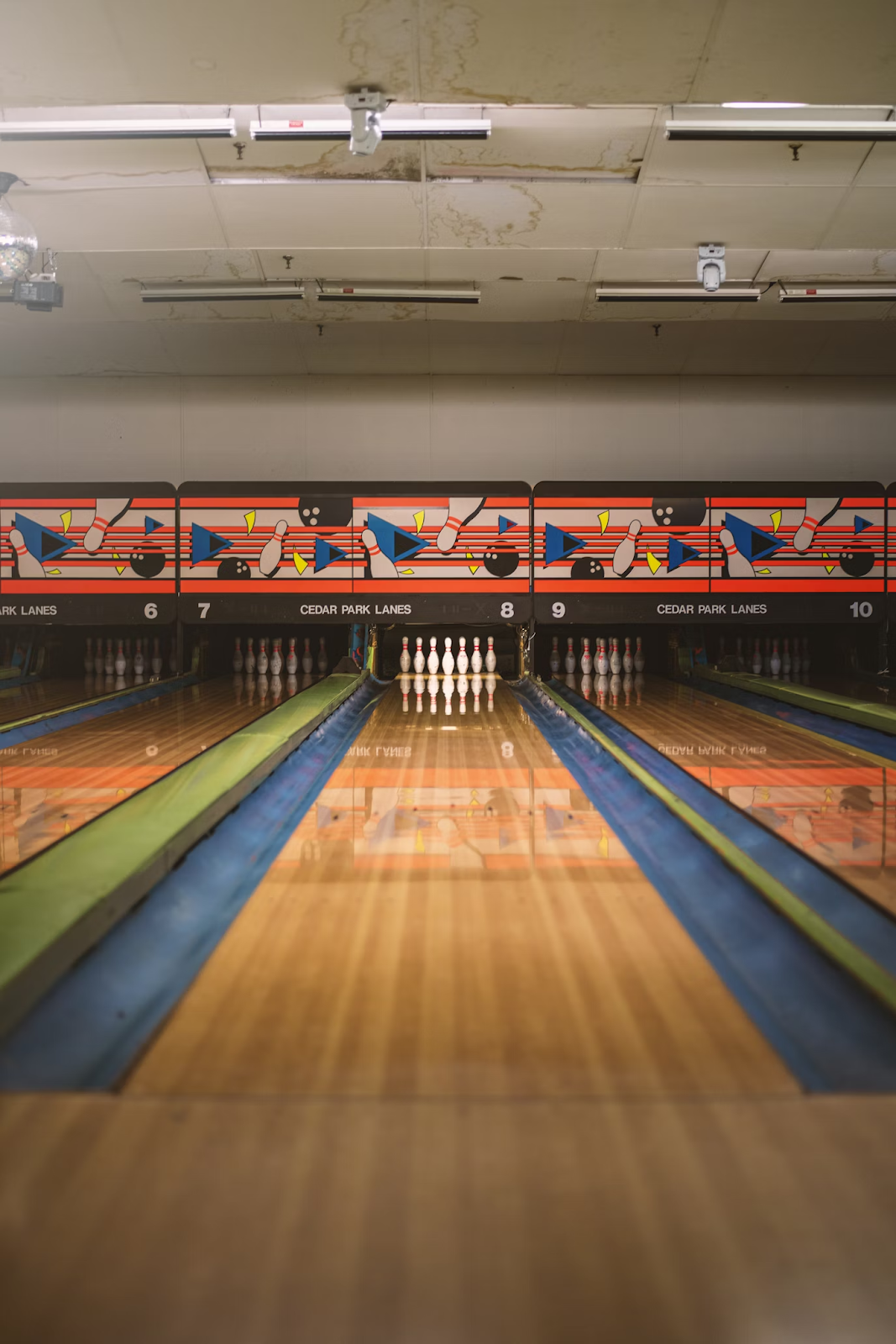 The picture shows a bowling alley where groups can have fun.