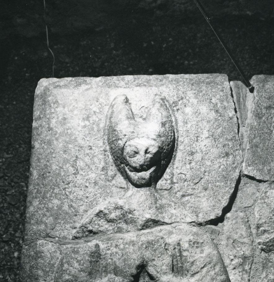 A stone carving of a bat

Description automatically generated