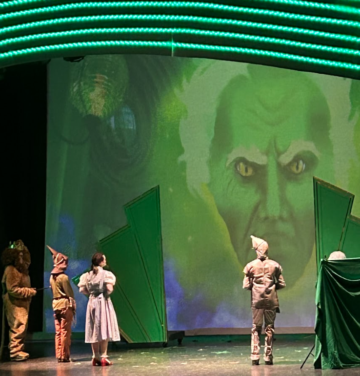 image of the middle school musical, The Wizard of Oz, showing Dorothy, the scarecrow, and the lion