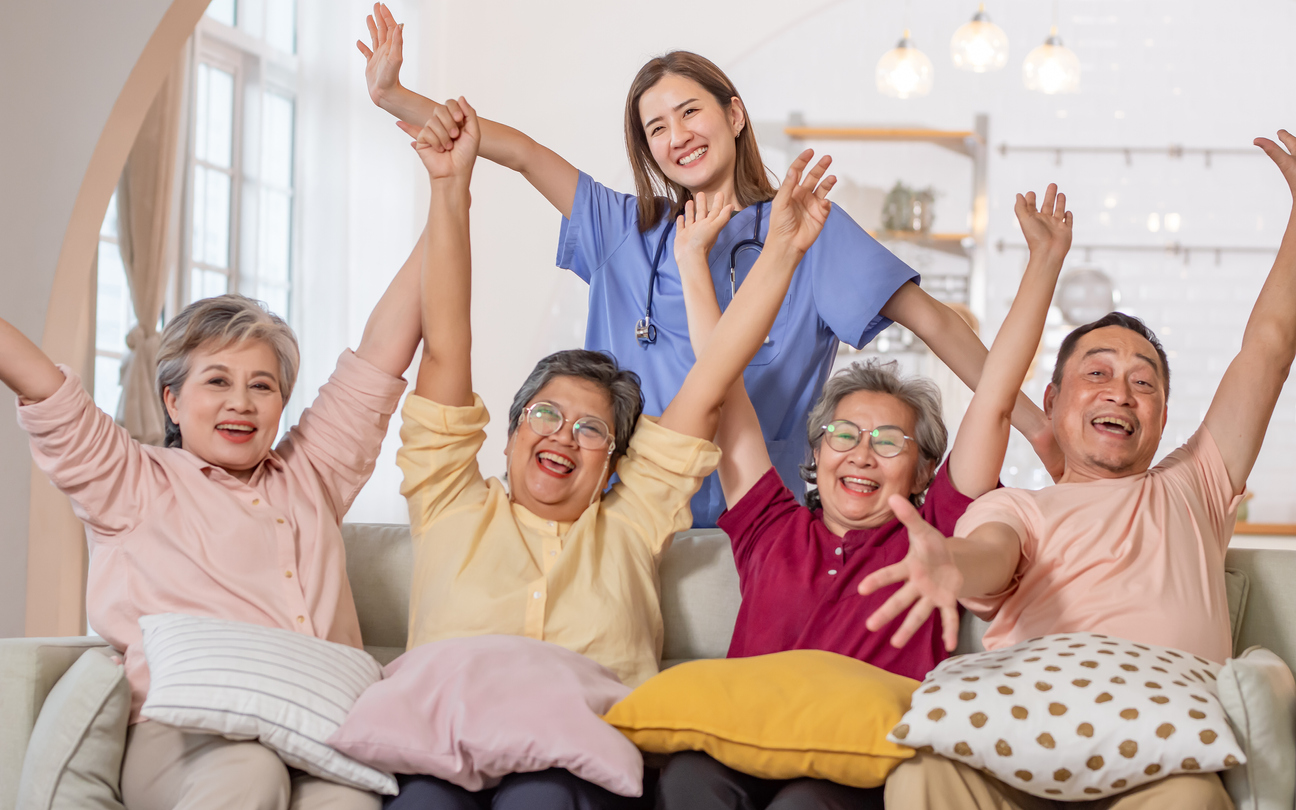 Happy group of seniors with nurse