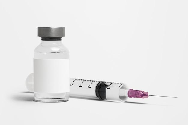 Blank white label on injection bottle glass vial with syringe