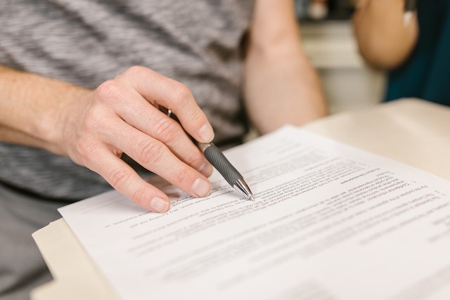 Person reviewing a document on their eviction process with a pen
