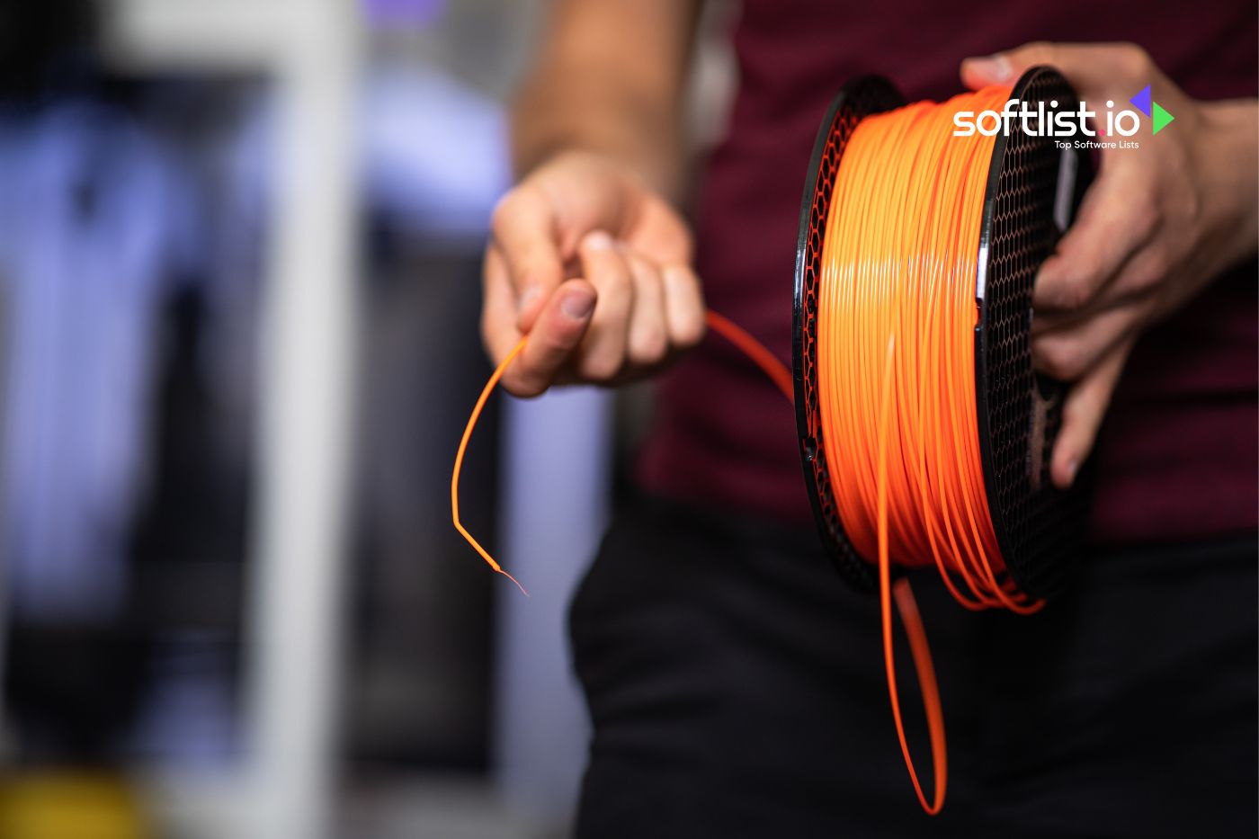 Person holding filament from spool