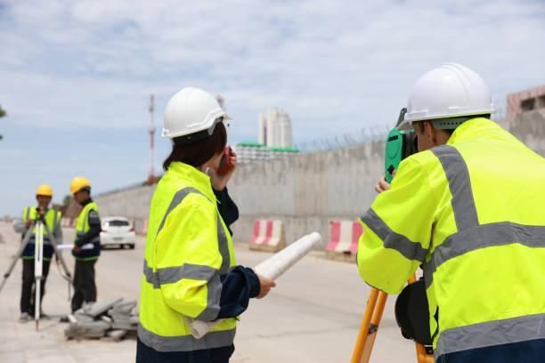 civil engineers teamwork at road construction sites to supervise new road construction and inspect road construction sites. road construction supervision. - the role of asphalt paving in infrastructure development stock pictures and images