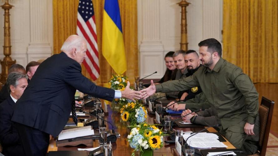U.S. President Joe Biden and Ukraine President Volodymyr Zelenskiy shake hands across the table during a meeting in the East Room of the White House in Washington, U.S. September 21, 2023.