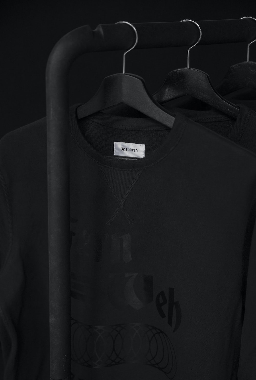 black crew-neck t-shirt on clothes hanger