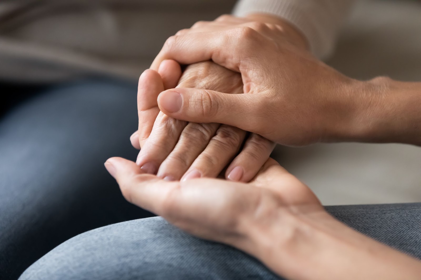 Two people holding hands, creating an atmosphere of comfort and support