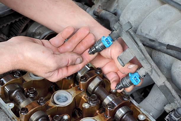 A person checking the injectors.
