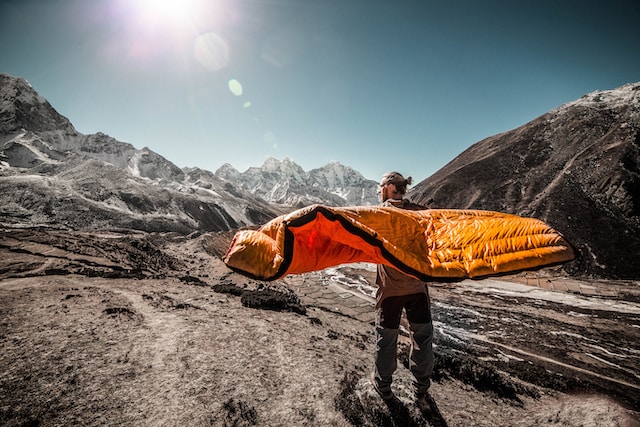 man carrying sleeping bag