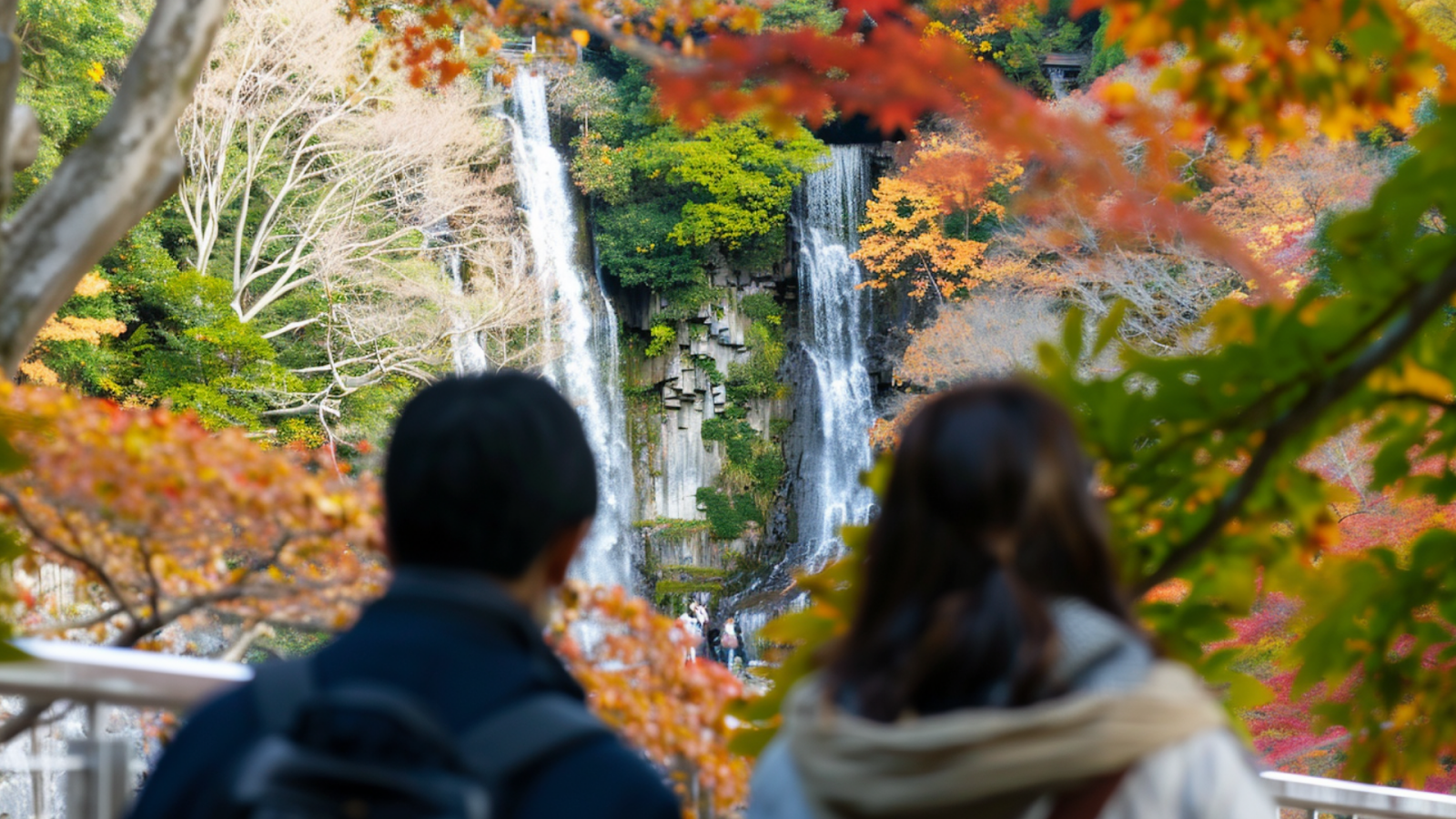 Two people looking at the Minoo Waterfalls in Osaka, Japan