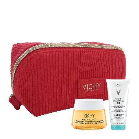 A red cosmetic bag with a few small bottles of cream and a small bottle of oil Description automatically generated
