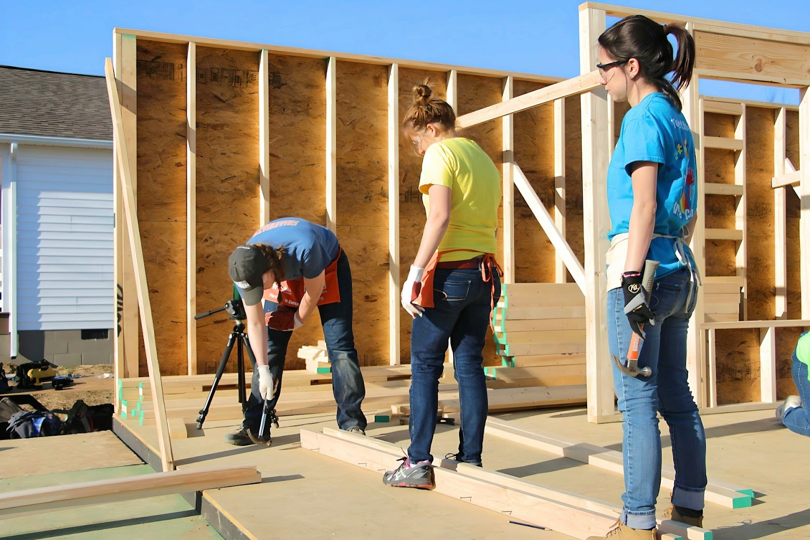 Three people working on a construction project