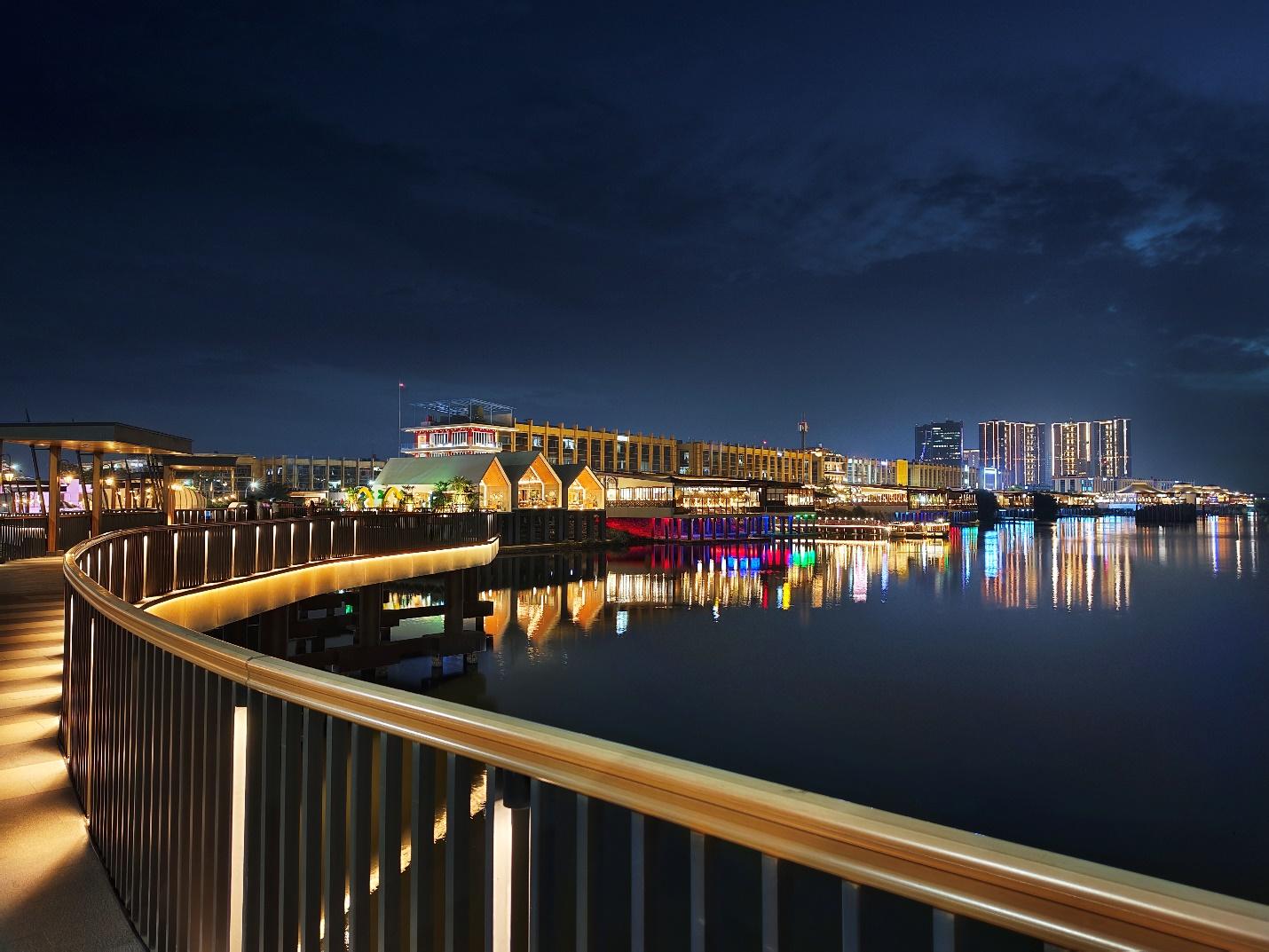 A bridge over water with buildings in the background

Description automatically generated