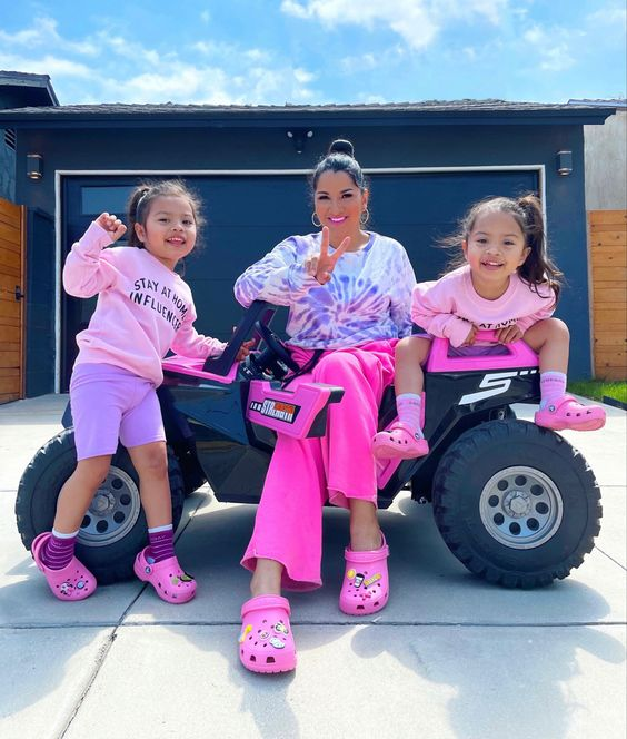 Picture showing a mun and her two kids accessorizing  their footwear  socks 