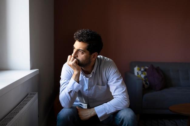 Free photo anxious man indoors front view