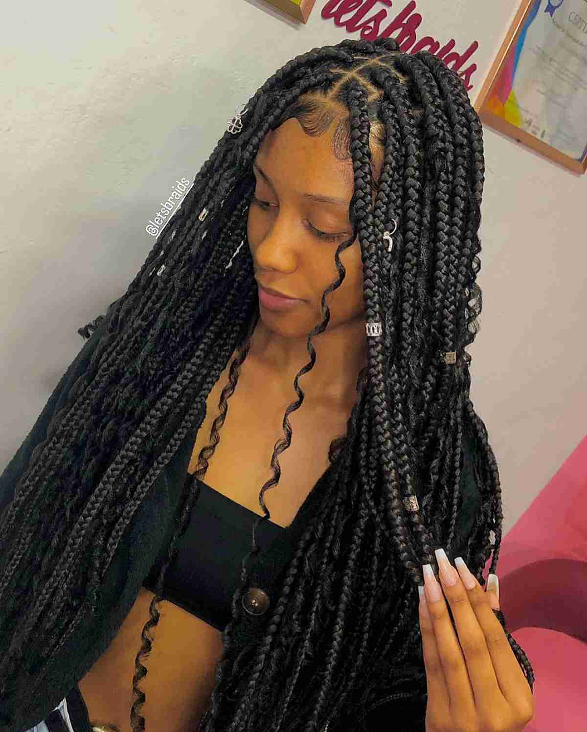 Picture of a lady rocking cuffs on her braided hairdo