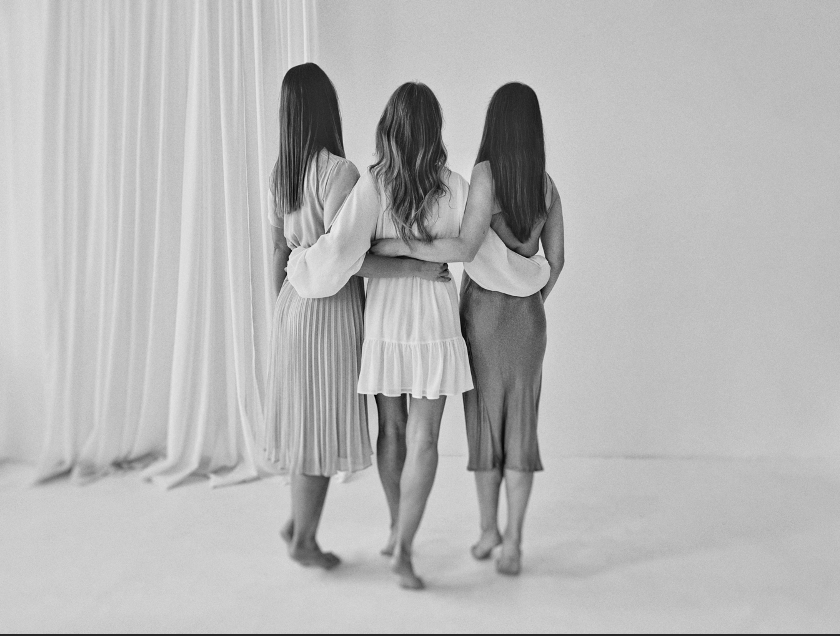 A group of women standing together</p>
<p>Description automatically generated