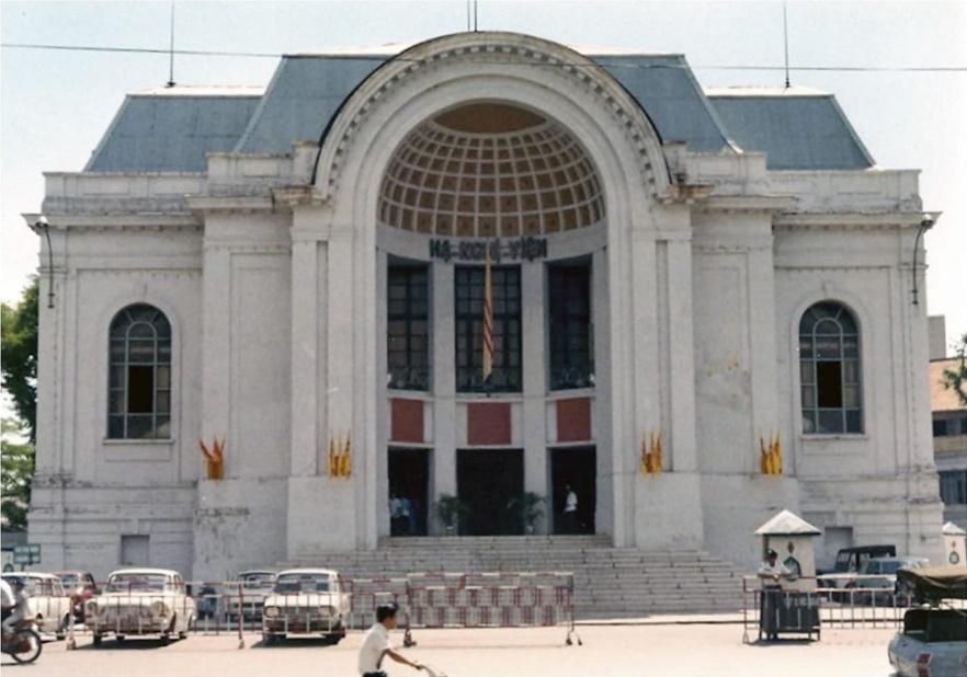 A white building with arched entryway

Description automatically generated