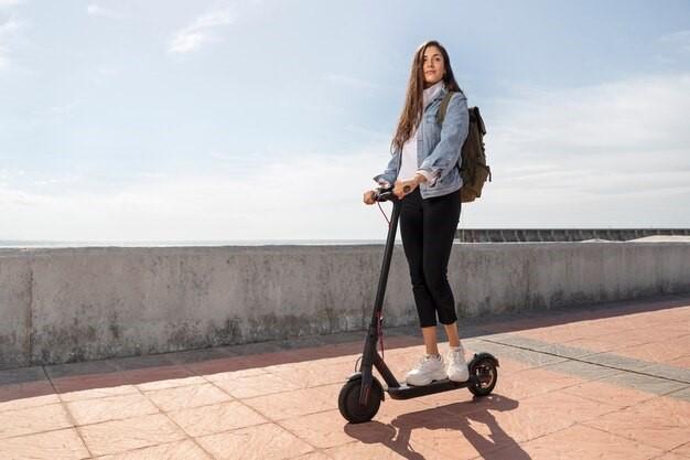 Young woman using a scooter outdoors
