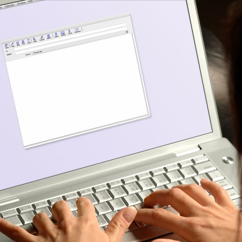 A person writing an email on a PC
