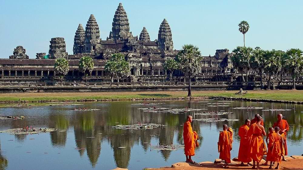 Buddhist monks in front of the reflection pool at Angkor Wat