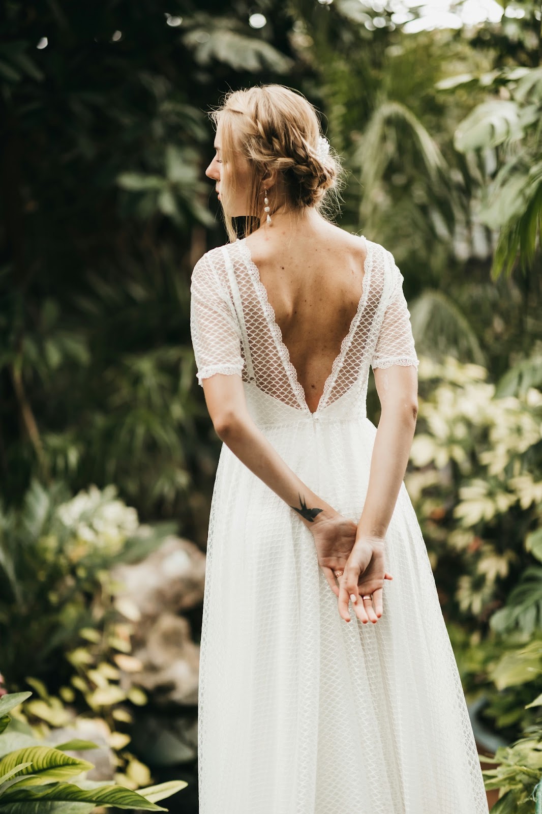 A bride  wearing a backless wedding dress with a stunning v-back design, adding allure to her bridal look.