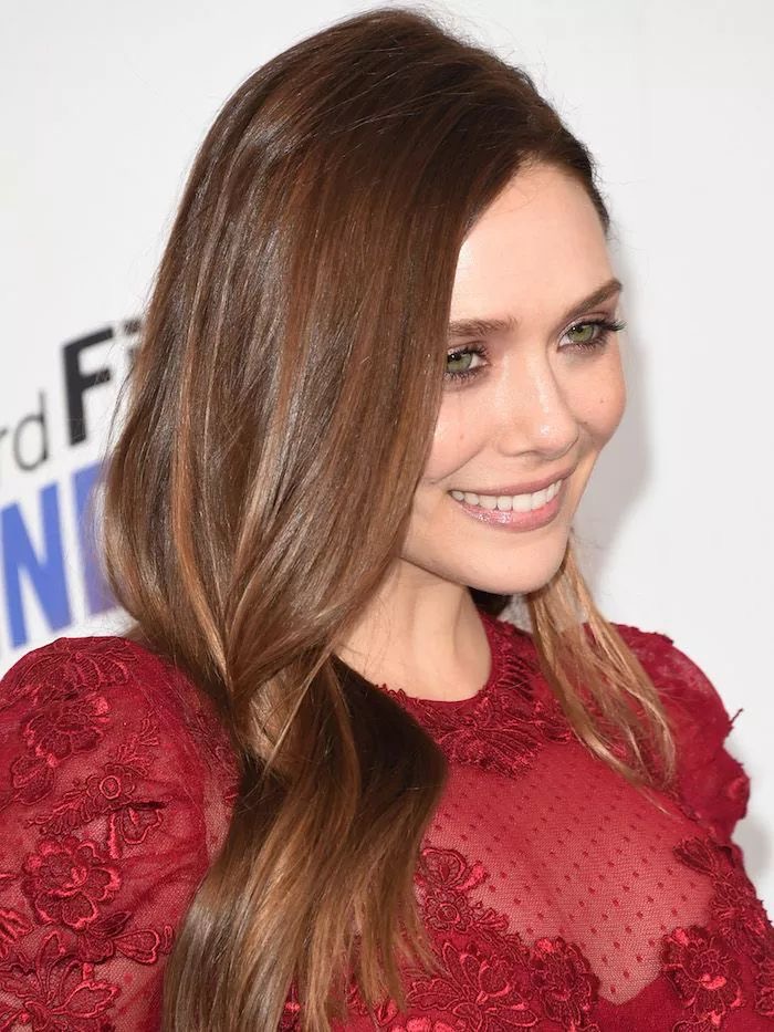 Elizabeth Olsen with brown hair that matches with her green eyes at the red carpet