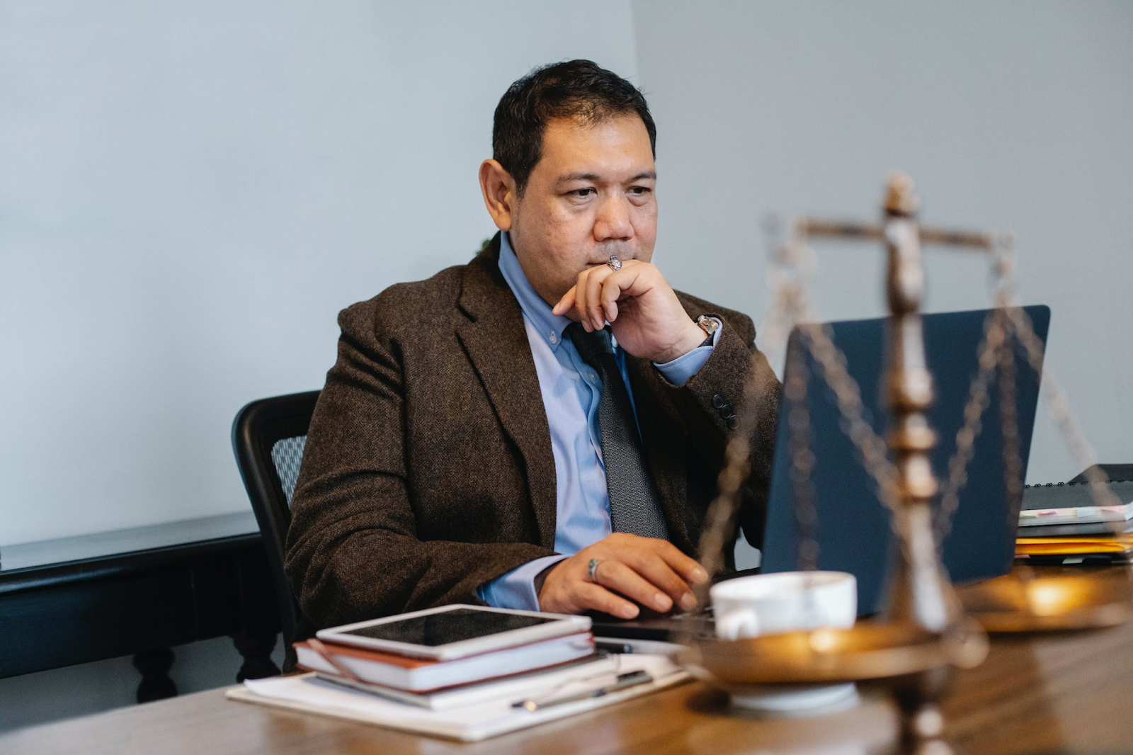 A lawyer wearing a suit with a laptop 