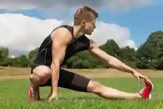 A man running on a desert dirt road, exemplifying one of the fitness habits that may harm the body before turning 50.
