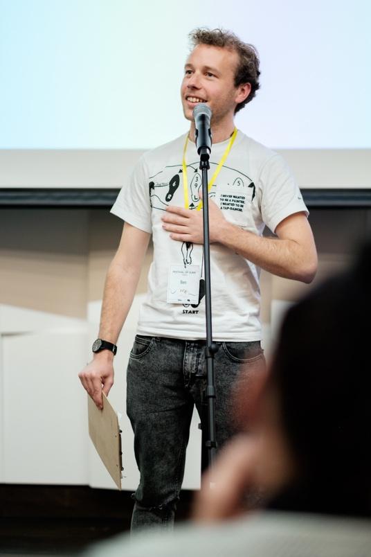 A person standing in front of a microphone

Description automatically generated