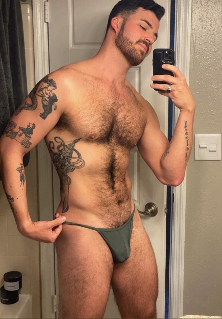 Dillon Cassidy showing off his hairy chest and treasure trail wearing a tiny green g string bikini