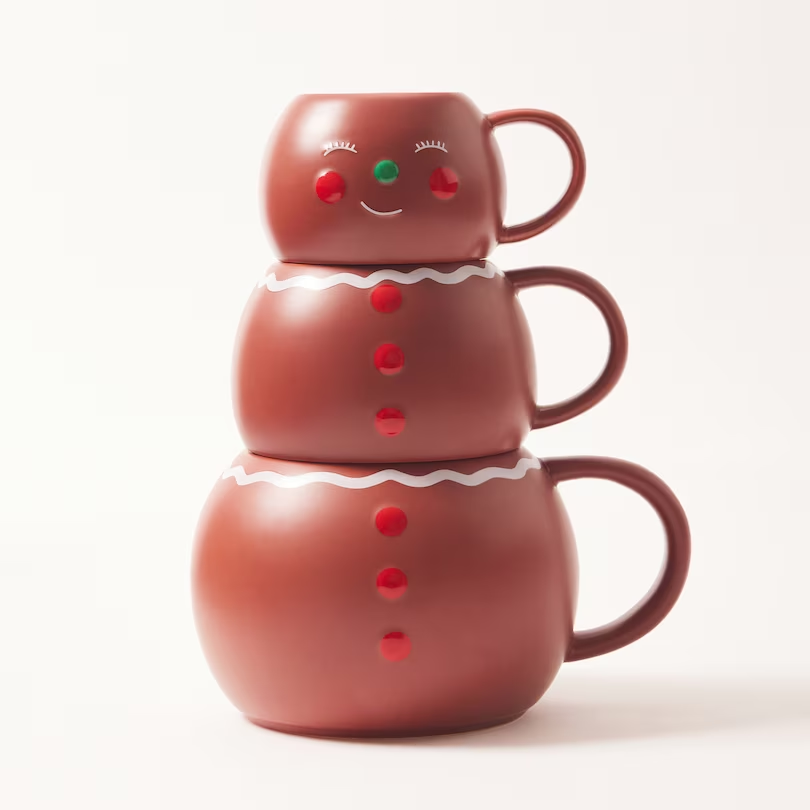 Bring magic to your mornings with the Indigo Gingerbread Man Stacking Mugs Set. This trio of stacking mugs, made from durable glazed stoneware, creates a charming gingerbread man when nested. With colorful glossy accents, wide handles, and a comfortable rounded profile, these mugs are perfect for the whole family. A great gift and delightful holiday decor addition, sip through the season in style.