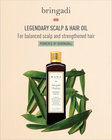 A bottle of hair oil with leaves around it

Description automatically generated