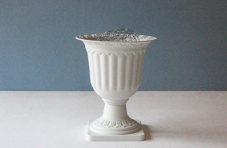 Chicken wire placed around the mouth of a vase 