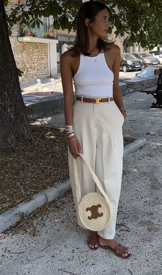 Picture of a lady rocking the belt with palazzo and white top