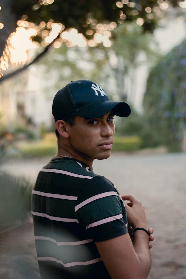 Guy shows off his cap rocking a headwear other than hat