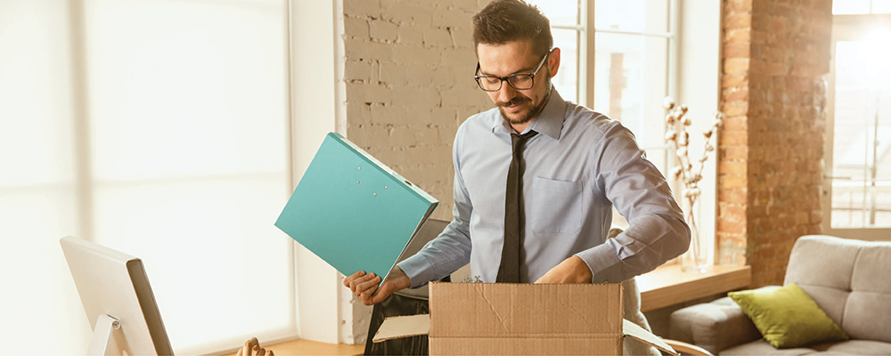 A remote worker storing stuff away in boxes for self storage
