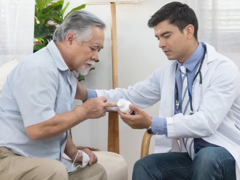 A doctor showing a person something to his patient

Description automatically generated