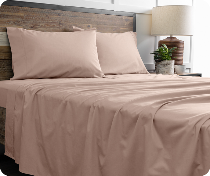 Our pink Bamboo Cotton Sheet Set in Frosted Berry shown on a bed.