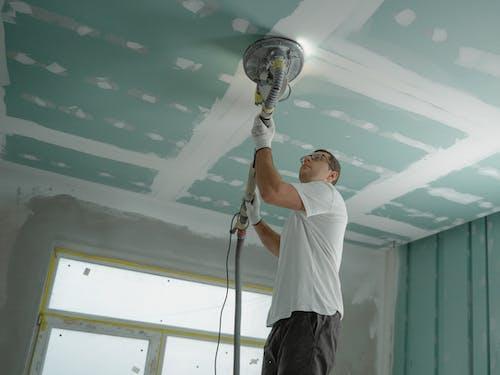 Free Man Polishing the Ceiling Stock Photo