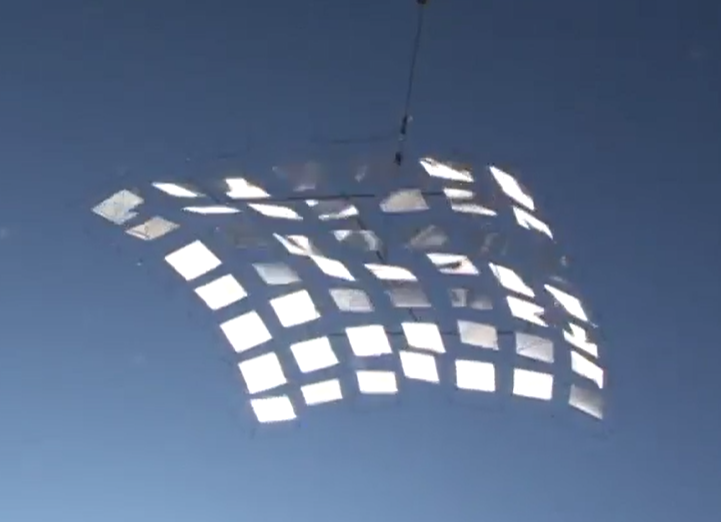 A light shining on a kite

Description automatically generated with medium confidence