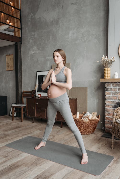 looking after your health during pregnancy, a pregnant lady doing yoga