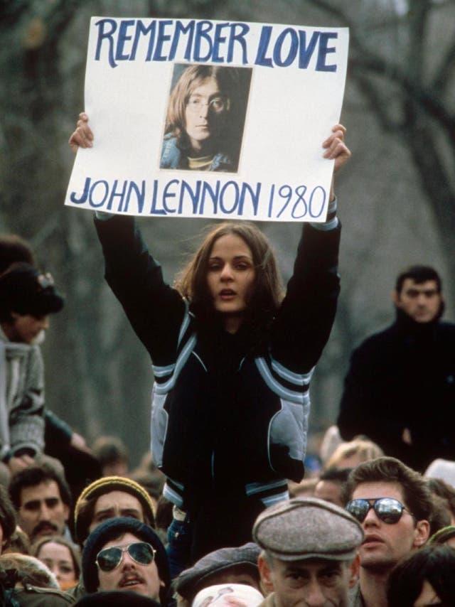 Mourning: a fan holds a sign remembering the murdered Lennon at a New York memorial in December 1980 (Shutterstock)
